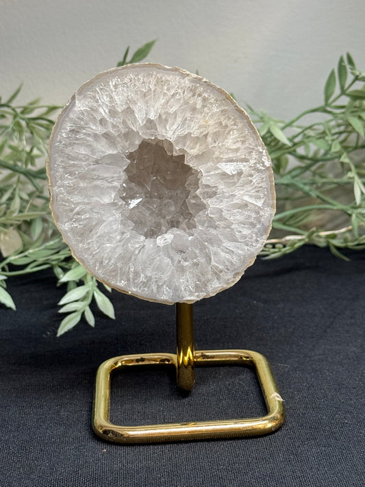 Agate geode half on gold stand